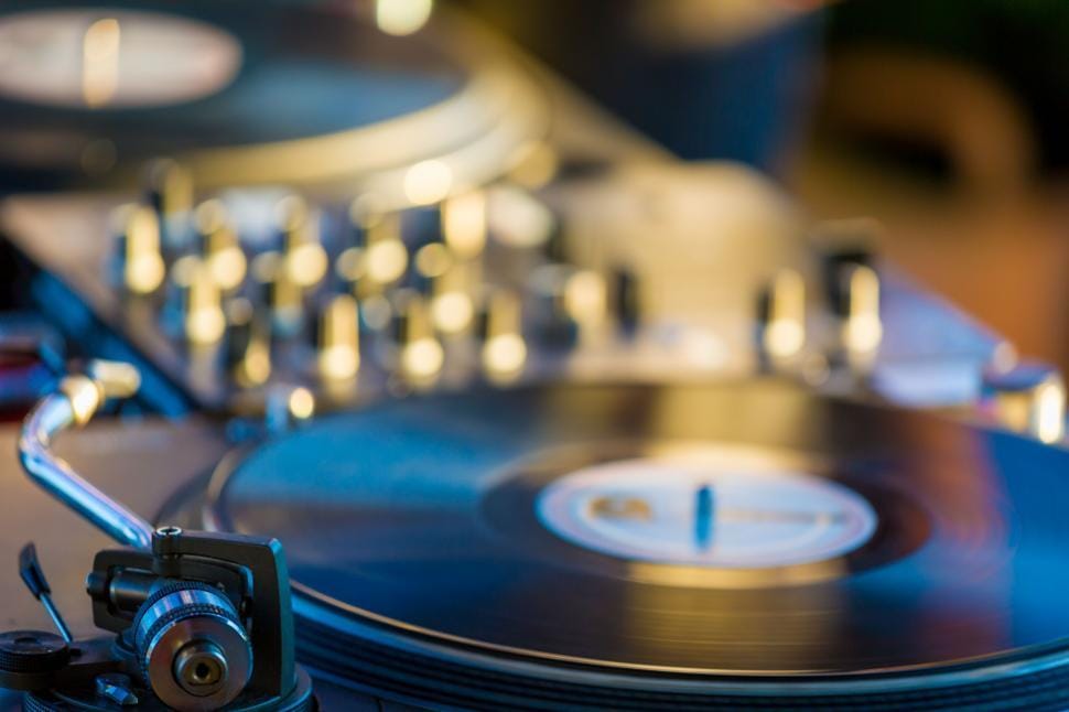 Close-up of a turntable needle on a vinyl record, representing audio archiving and remixing