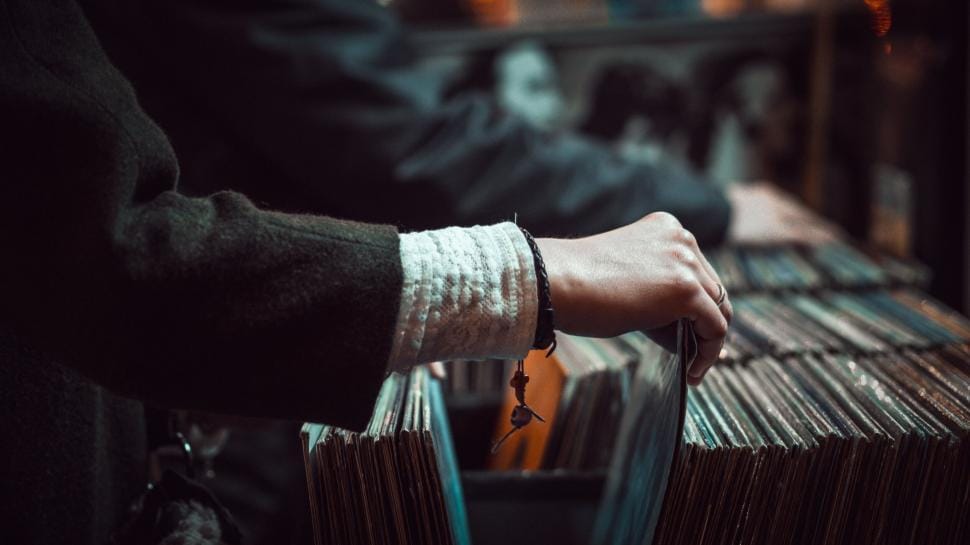 Rows of vinyl records filed in crates, representing archival hip-hop collections